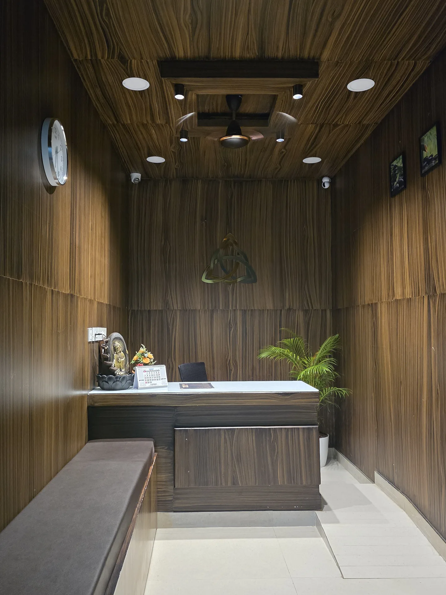 Tris Wellness Spa reception — teakwood and warm brass lighting